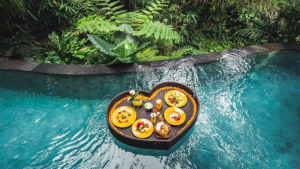 Luxury floating breakfast with fresh fruit and pastries on an infinity pool at a Bali villa